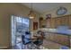 Bright breakfast nook with a round table, upholstered chairs, and sliding glass doors at 9785 E Preserve Way, Scottsdale, AZ 85262