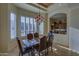 Inviting dining area with shuttered windows and a view into the adjacent kitchen space at 9785 E Preserve Way, Scottsdale, AZ 85262