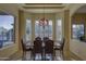 Bright dining room featuring a large window with shutters and an elegant chandelier at 9785 E Preserve Way, Scottsdale, AZ 85262