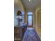 Elegant entryway with a patterned rug, wooden console table, and decorative mirror at 9785 E Preserve Way, Scottsdale, AZ 85262