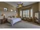 Serene main bedroom with a sitting area, large windows, and a ceiling fan at 9785 E Preserve Way, Scottsdale, AZ 85262