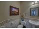 Chic powder room with tiled walls, framed artwork, and decorative fixtures at 9785 E Preserve Way, Scottsdale, AZ 85262