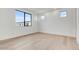 Bedroom featuring bright natural light, hardwood floors, and modern minimalist design at 100 W Northern Ave # 13, Phoenix, AZ 85021