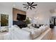 Open-concept living room featuring a fireplace, hardwood floors, a ceiling fan, and seamless access to the dining area at 100 W Northern Ave # 17, Phoenix, AZ 85021