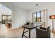 Bright home office with hardwood floors, modern desk, chair, and natural light from the large window at 100 W Northern Ave # 5, Phoenix, AZ 85021