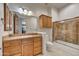 Bathroom features a stone countertop, vanity mirror, and a tiled shower with glass door at 10396 N 133Rd St, Scottsdale, AZ 85259