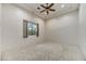 Bright bedroom featuring neutral carpet, a window, and a ceiling fan at 10396 N 133Rd St, Scottsdale, AZ 85259