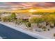 Beautiful exterior home with desert landscaping, mature trees, and sunset backdrop at 10396 N 133Rd St, Scottsdale, AZ 85259
