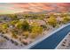 Upscale property amidst lush desert landscaping and beautiful homes under a colorful sky at 10396 N 133Rd St, Scottsdale, AZ 85259