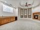 Living room with a fireplace, custom cabinets and a large window with unique design at 10396 N 133Rd St, Scottsdale, AZ 85259