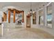Living room with travertine floor, columns, chandelier, stairs, and large windows with beautiful outside views at 10396 N 133Rd St, Scottsdale, AZ 85259