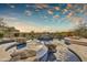 Resort-style swimming pool with rock features, waterfall, and a separate fire pit lounge area at 10396 N 133Rd St, Scottsdale, AZ 85259