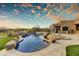 Beautiful swimming pool with rock features, lush landscaping, and open patio space for entertaining at 10396 N 133Rd St, Scottsdale, AZ 85259