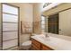 Bathroom features a vanity with a wood cabinet and a shower at 10726 W Pineaire Dr, Sun City, AZ 85351