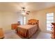 Bright bedroom with light carpet, ceiling fan, and natural light at 10726 W Pineaire Dr, Sun City, AZ 85351
