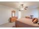 Comfortable bedroom with carpet, a ceiling fan, and lots of natural light at 10726 W Pineaire Dr, Sun City, AZ 85351