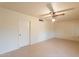 Neutral bedroom featuring tile flooring, a ceiling fan, and a closet at 10726 W Pineaire Dr, Sun City, AZ 85351