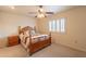 Neutral bedroom featuring a ceiling fan, a window with shutters, and carpeted floors at 10726 W Pineaire Dr, Sun City, AZ 85351