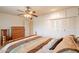 Bright bedroom featuring a ceiling fan, large closet, and natural light at 10726 W Pineaire Dr, Sun City, AZ 85351