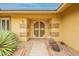 Close-up of a home's elegant, sheltered entryway and desert-style landscaping at 10726 W Pineaire Dr, Sun City, AZ 85351