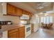 Cozy kitchen with white appliances and ample cabinet space, adjacent to a breakfast nook at 10726 W Pineaire Dr, Sun City, AZ 85351