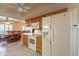 A view into the kitchen, featuring white appliances and view of the dining area at 10726 W Pineaire Dr, Sun City, AZ 85351