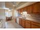 Functional kitchen with wood cabinets and a view of the adjacent breakfast nook at 10726 W Pineaire Dr, Sun City, AZ 85351