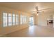 Bright living room features tiled flooring, large windows, and a sliding glass door to the patio at 10726 W Pineaire Dr, Sun City, AZ 85351