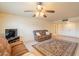 Inviting living area with comfortable seating, a ceiling fan, and neutral walls at 10726 W Pineaire Dr, Sun City, AZ 85351