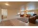 Spacious living room featuring tile floors, a ceiling fan, and ample seating at 10726 W Pineaire Dr, Sun City, AZ 85351