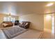 Bright living room with plush seating, a large rug, and a neutral color palette at 10726 W Pineaire Dr, Sun City, AZ 85351