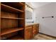 Bathroom showcasing dual vanity with backlit mirror, wood cabinets, and tile flooring at 1210 E Harmony Cir, Mesa, AZ 85204