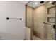 Bathroom featuring a shower with glass enclosure, modern fixtures and tiled surround at 1210 E Harmony Cir, Mesa, AZ 85204