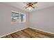 Bedroom with wood floor, ceiling fan, and window at 1210 E Harmony Cir, Mesa, AZ 85204