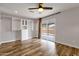 Bedroom with closet system, ceiling fan, sliding glass door and wood floors at 1210 E Harmony Cir, Mesa, AZ 85204