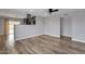 Spacious room featuring wood-look flooring, ceiling fan and neutral paint color at 1210 E Harmony Cir, Mesa, AZ 85204