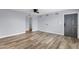 Expansive living room with modern ceiling fan, wood flooring, and neutral paint at 1210 E Harmony Cir, Mesa, AZ 85204