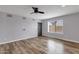 Living room features neutral paint, wood flooring and ceiling fan at 1210 E Harmony Cir, Mesa, AZ 85204