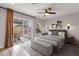 Inviting main bedroom featuring a sliding glass door to the patio, neutral color palette, and artwork at 1210 E Harmony Cir, Mesa, AZ 85204