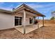 Covered patio featuring painted support beams, leading to a backyard, with a gravel ground cover and desert landscaping at 1210 E Harmony Cir, Mesa, AZ 85204