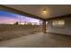 Covered patio featuring concrete floors and an open view of the backyard, ideal for outdoor relaxation and entertaining at 1210 E Harmony Cir, Mesa, AZ 85204