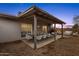 Charming covered patio is perfect for outdoor entertaining and relaxation at 1210 E Harmony Cir, Mesa, AZ 85204