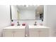 Elegant bathroom featuring double vanities, sleek mirrors, and modern fixtures for a luxurious feel at 1216 N 66Th Pl, Mesa, AZ 85205