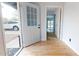 Inviting entryway featuring a glass-paneled door and hardwood floors at 1216 N 66Th Pl, Mesa, AZ 85205