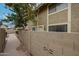 Property exterior featuring a lemon tree, walkway, and privacy fence at 1223 N Granite Reef Rd, Scottsdale, AZ 85257