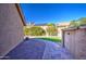 Paver walkway surrounded by gravel and artificial grass in fenced backyard with blue skies at 13214 S 39Th St, Phoenix, AZ 85044