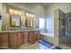 Bright bathroom with a soaking tub, double sink vanity with granite counters and glass-enclosed shower at 13214 S 39Th St, Phoenix, AZ 85044