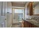 Bathroom with a glass block shower and granite countertop vanity at 13214 S 39Th St, Phoenix, AZ 85044