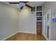 Bedroom featuring hardwood floors, ceiling fan, and built-in shelving at 13214 S 39Th St, Phoenix, AZ 85044