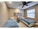 Bedroom with two twin beds, a ceiling fan, and a window for natural light and comfortable sleeping quarters at 13214 S 39Th St, Phoenix, AZ 85044